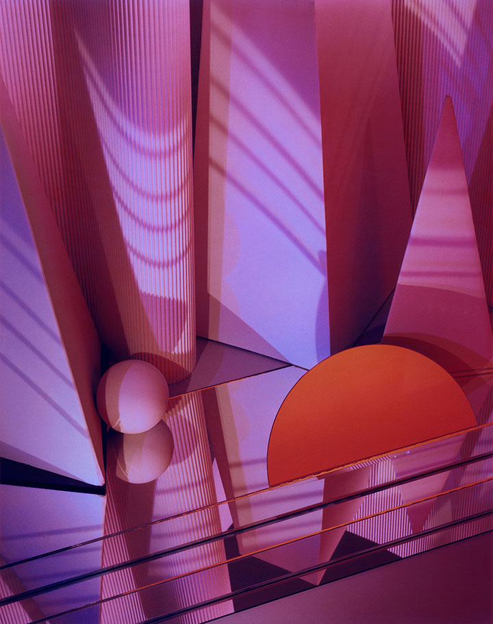 Abstract photo in vertical orientation featuring shapes in various hues of red.