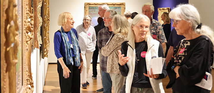 Several Museum-goers looking at artwork in the galleries