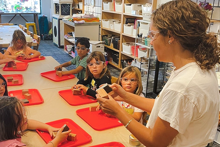photo of instructor teaching kids at crafting table